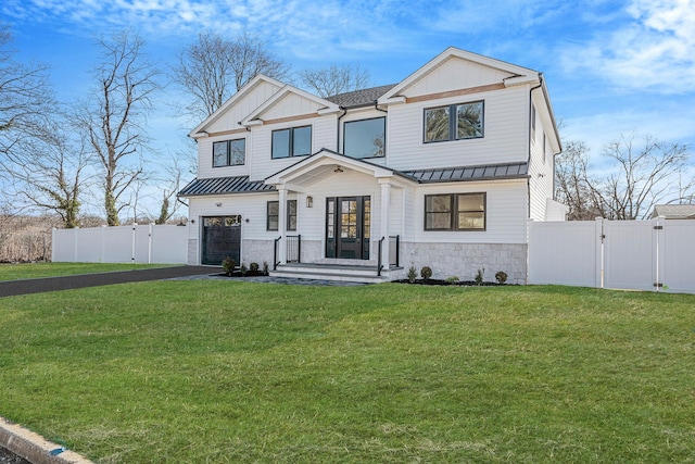 modern farmhouse style home featuring fence, driveway, a gate, a front lawn, and a standing seam roof