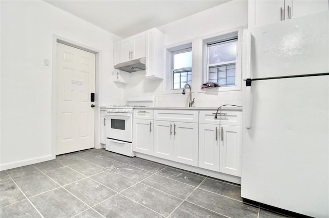 kitchen featuring tile patterned floors, sink, white cabinetry, tasteful backsplash, and white appliances