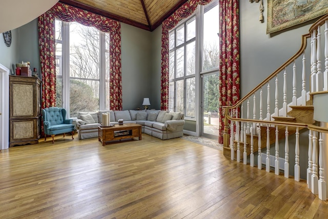 sitting room featuring a wealth of natural light, wood-type flooring, and high vaulted ceiling