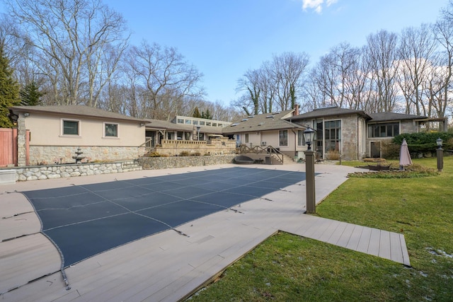 view of swimming pool with a yard and a patio