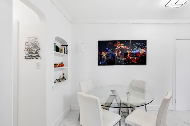 dining space featuring built in shelves