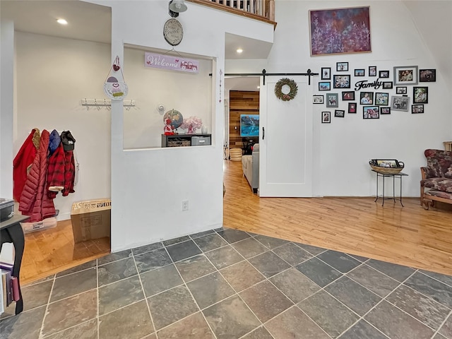 interior space featuring a barn door and dark wood-type flooring