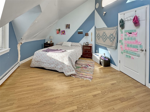 bedroom with a baseboard radiator, vaulted ceiling, and light hardwood / wood-style flooring