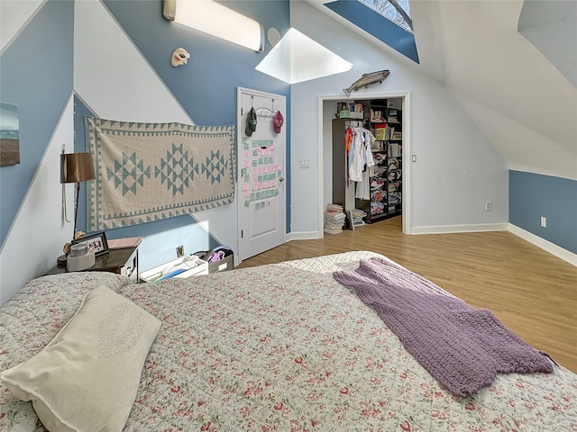 bedroom featuring wood-type flooring and vaulted ceiling