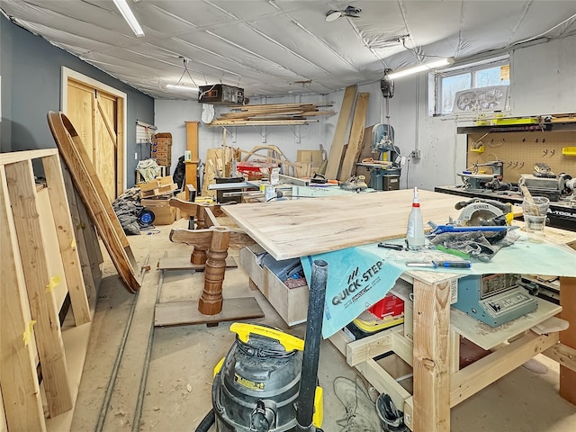 miscellaneous room with concrete flooring and a workshop area