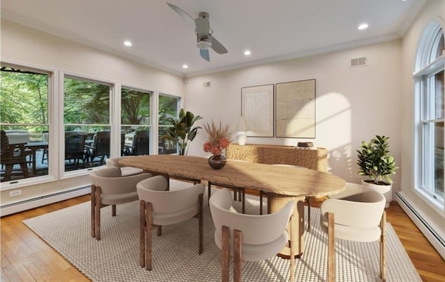 dining space featuring plenty of natural light, baseboard heating, and light hardwood / wood-style flooring