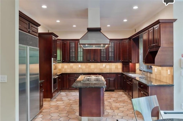 kitchen featuring island range hood, tasteful backsplash, sink, a center island, and stainless steel appliances