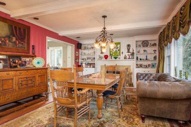 dining room featuring hardwood / wood-style flooring, built in features, a notable chandelier, ornamental molding, and beamed ceiling