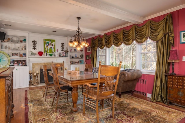 dining area with a chandelier, dark wood-style flooring, visible vents, beam ceiling, and radiator heating unit