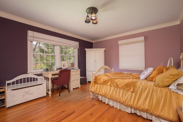 bedroom featuring ornamental molding and light wood-style floors