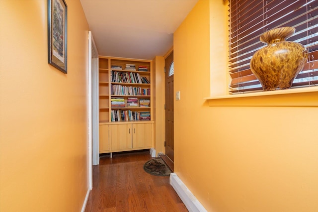 hall with dark wood finished floors and baseboards