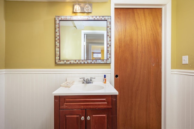 bathroom featuring a wainscoted wall and vanity