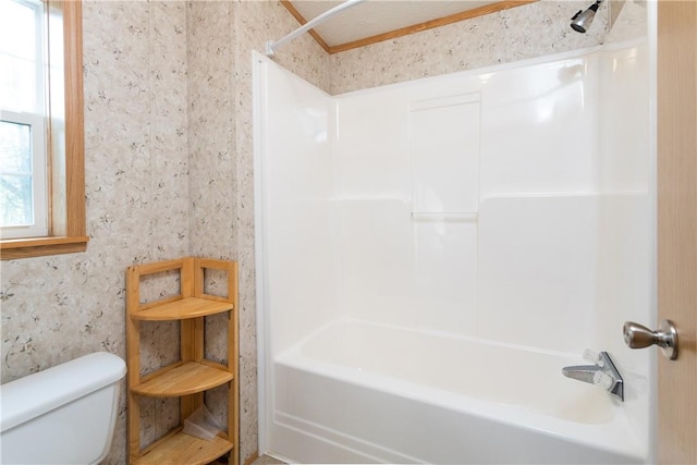 bathroom with shower / bathing tub combination and toilet