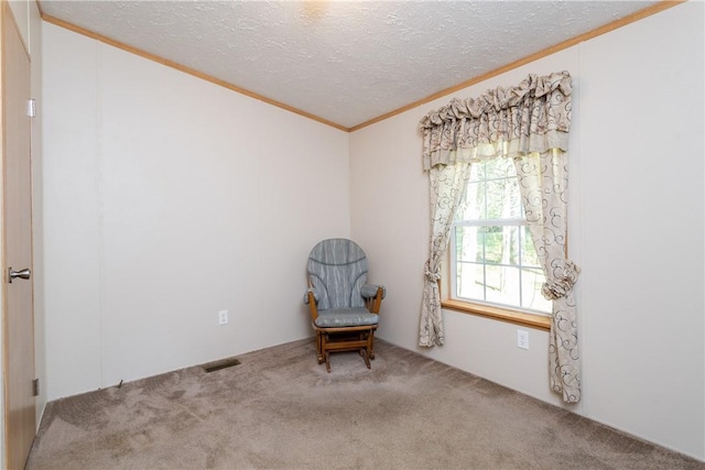 unfurnished room featuring ornamental molding, carpet flooring, and a textured ceiling