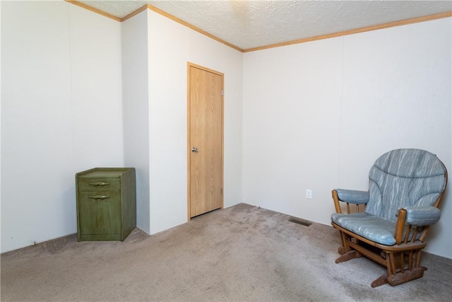 living area with ornamental molding, light carpet, and a textured ceiling