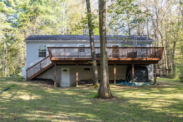 back of property with a wooden deck and a yard