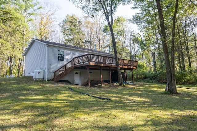 rear view of house with a yard and a deck