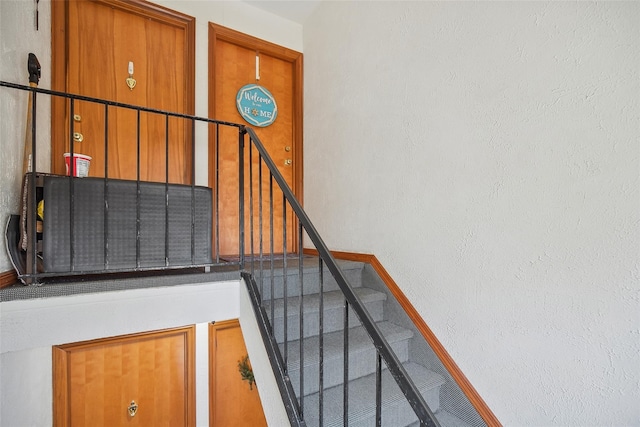 staircase featuring baseboards