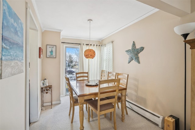 dining area featuring a baseboard heating unit, light carpet, baseboards, and crown molding