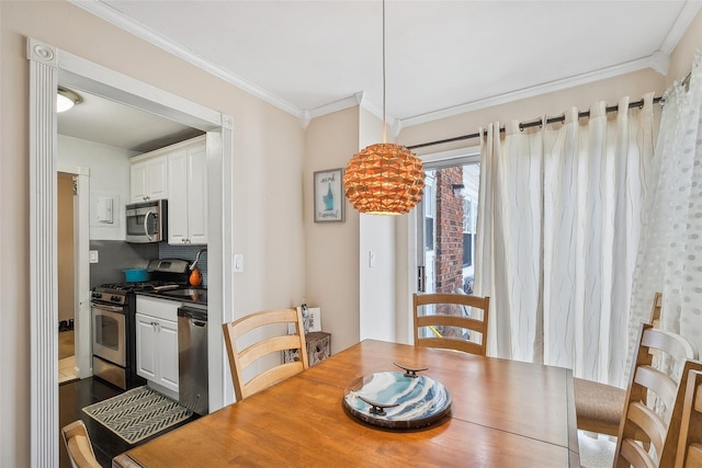 dining area featuring crown molding