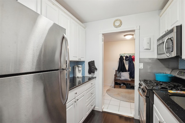 kitchen with white cabinetry, appliances with stainless steel finishes, and tasteful backsplash