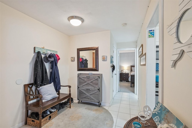 interior space with baseboards and light tile patterned floors