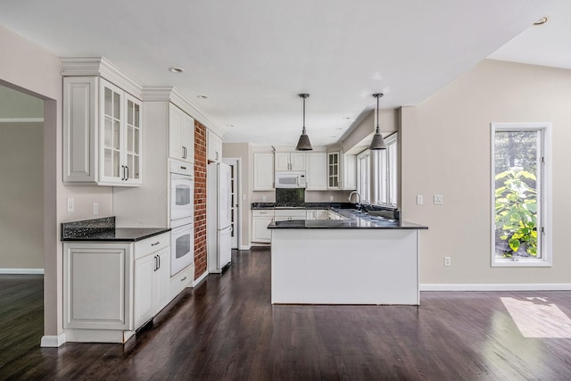 10 Clearbrook Dr, Smithtown, NY 11787 - kitchen with white appliances, a sink, dark wood-style floors, dark countertops, and baseboards