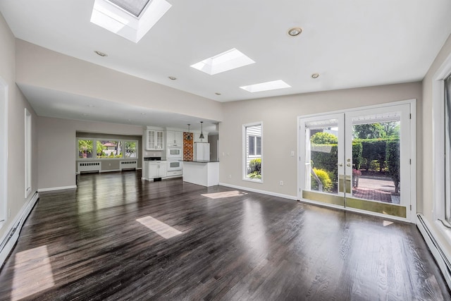 10 Clearbrook Dr, Smithtown, NY 11787 - unfurnished living room with a baseboard radiator, a skylight, dark wood-style flooring, and recessed lighting