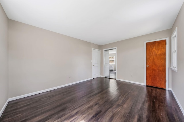 10 Clearbrook Dr, Smithtown, NY 11787 - spare room featuring baseboards and dark wood-style flooring