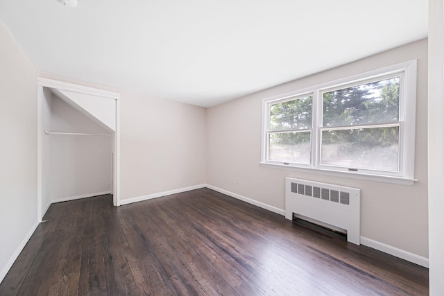 10 Clearbrook Dr, Smithtown, NY 11787 - unfurnished room with radiator heating unit, dark wood finished floors, and baseboards