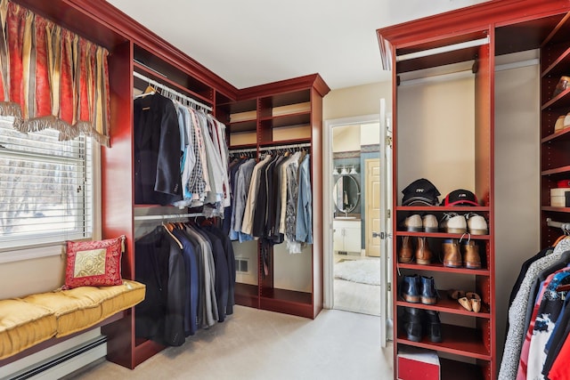 spacious closet with light carpet and baseboard heating