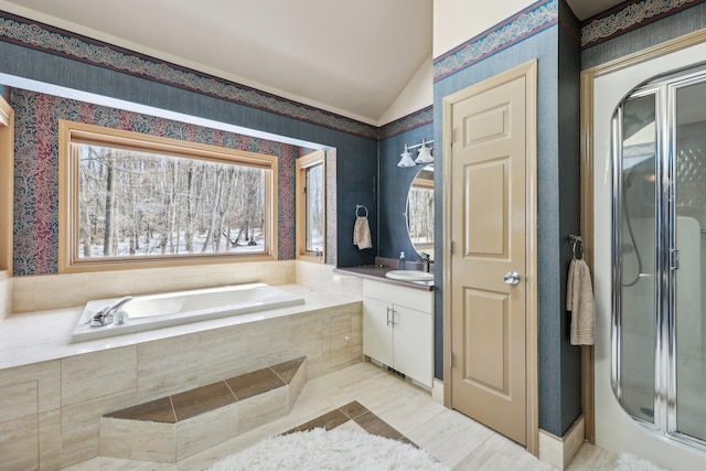 bathroom with vanity, vaulted ceiling, and shower with separate bathtub