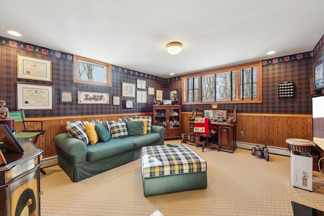 living room featuring baseboard heating, carpet flooring, and a wealth of natural light