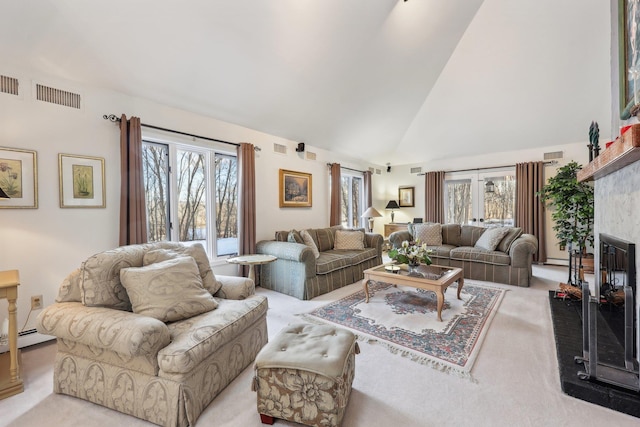 carpeted living room featuring a baseboard heating unit, high vaulted ceiling, and a wealth of natural light