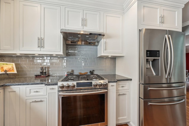 kitchen with appliances with stainless steel finishes, dark stone countertops, white cabinets, and decorative backsplash