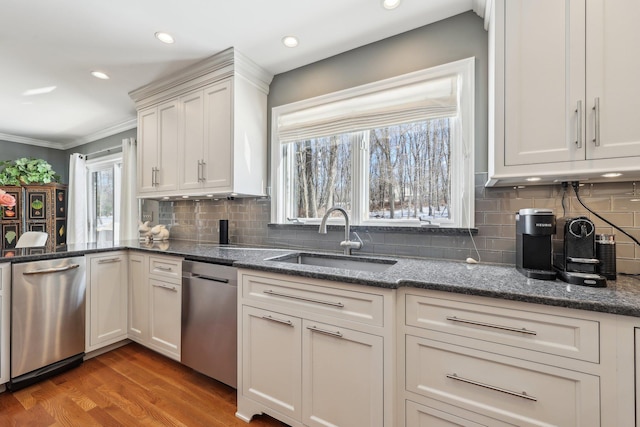 kitchen with wood-type flooring, white cabinetry, dishwasher, and sink