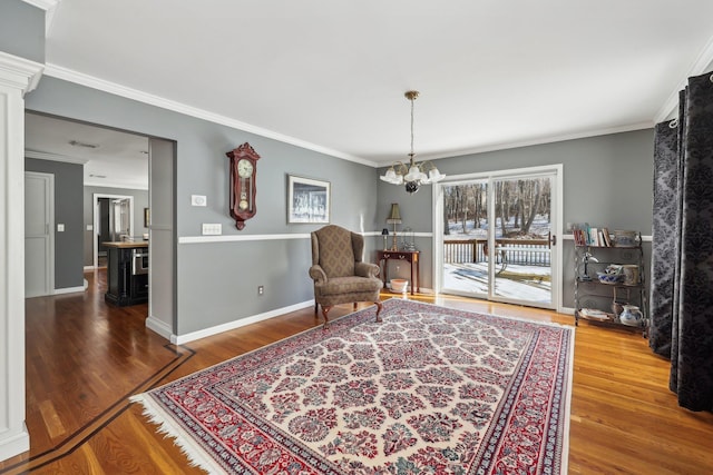 sitting room featuring ornamental molding and hardwood / wood-style flooring