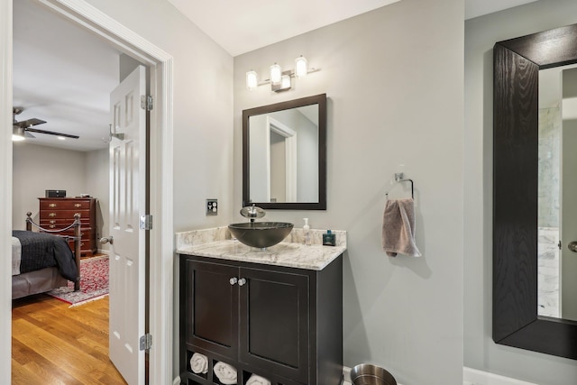 bathroom with vanity, ceiling fan, and wood-type flooring