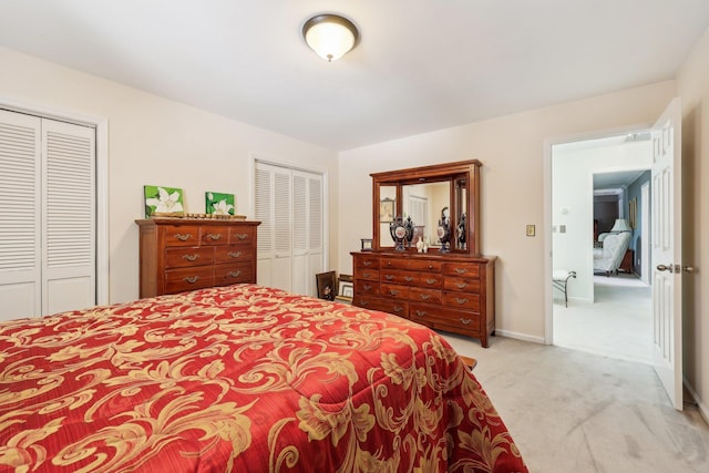 carpeted bedroom with two closets