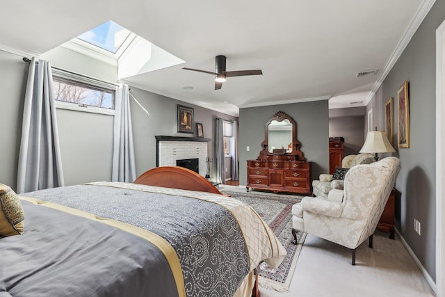 bedroom with carpet floors, ornamental molding, a brick fireplace, and ceiling fan