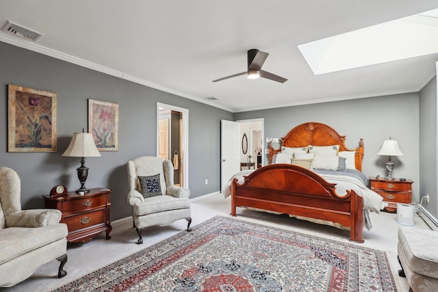 bedroom with carpet, ceiling fan, a skylight, and ornamental molding