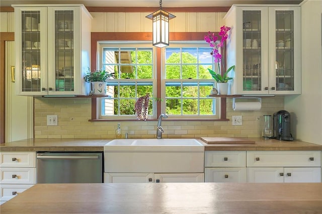 kitchen with sink, white cabinetry, tasteful backsplash, dishwasher, and pendant lighting