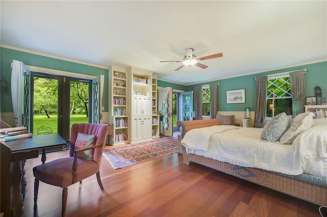 bedroom with hardwood / wood-style floors, crown molding, french doors, and access to exterior