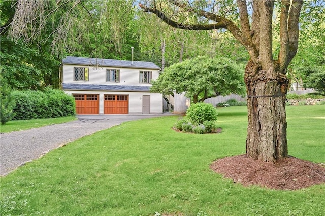 view of front facade with a garage and a front lawn