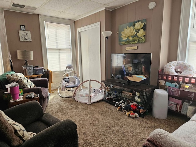 living room with carpet and a drop ceiling