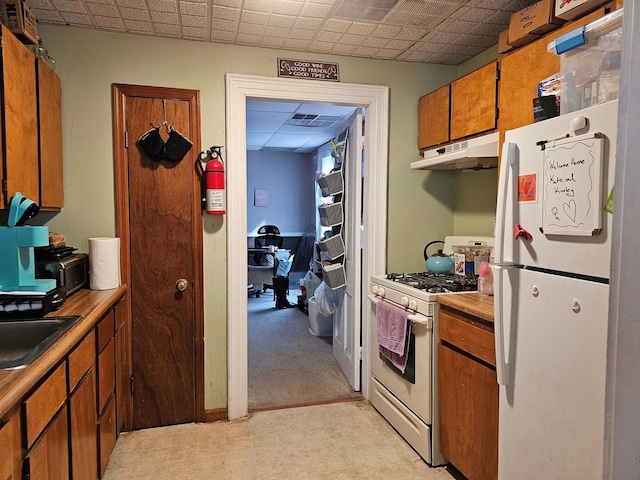 kitchen with sink and white appliances