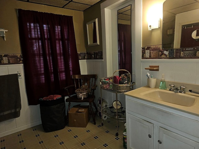 bathroom with vanity and a paneled ceiling