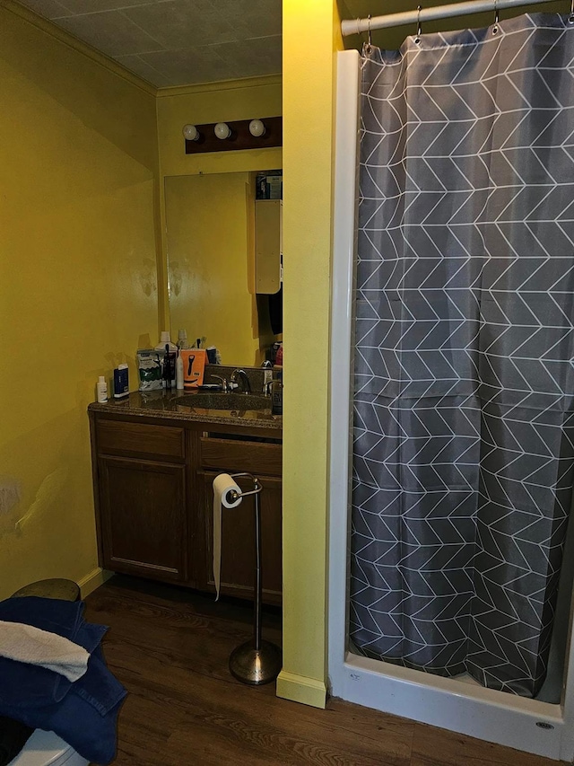 bathroom featuring vanity, curtained shower, and hardwood / wood-style floors