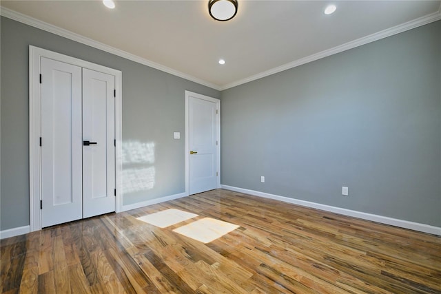 unfurnished bedroom featuring hardwood / wood-style flooring and ornamental molding