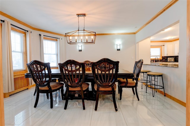 dining room with sink and crown molding